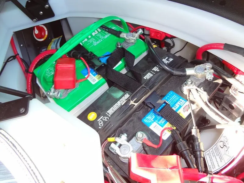 Slide: The Image of Battery compartment of 2023 Berkshire 25RFX STS 3.0+ boat, showing wiring and connections. - 44