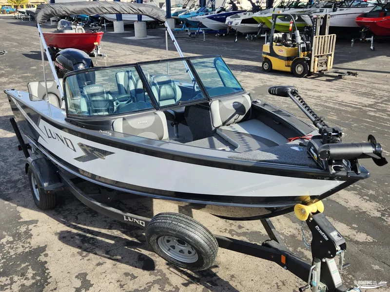 Slide: The Image of 2023 Lund 1775 Crossover XS boat on trailer, parked in marina. - 3