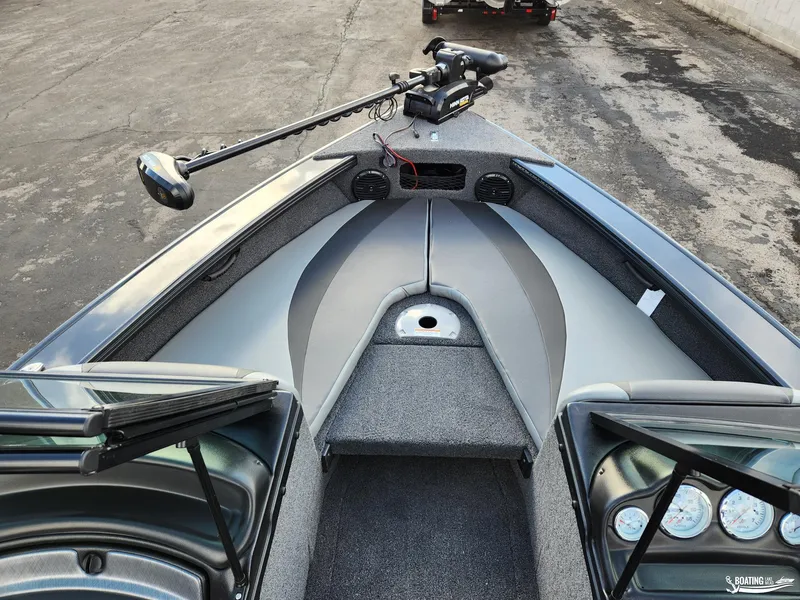 Slide: The Image of 2023 Lund 1775 Crossover XS boat interior with trolling motor and seating area. - 4