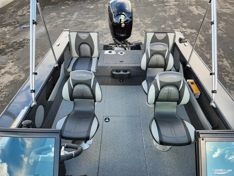 Slide: The Image of 2023 Lund 1775 Crossover XS boat interior with four seats and motor. - 5