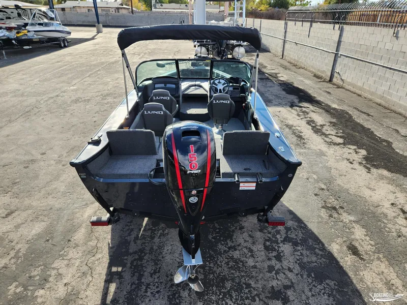 Slide: The Image of 2023 Lund 1775 Crossover XS boat with Mercury 150 engine, parked outdoors. - 9