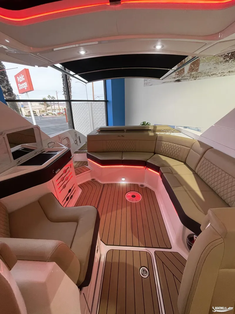 Slide: The Image of Luxurious interior of 2023 Sea Ray 310 SLX boat with ambient lighting and plush seating. - 11
