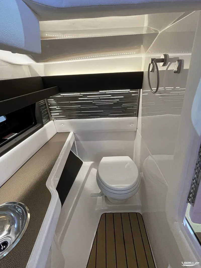 Slide: The Image of 2023 Sea Ray 310 SLX boat interior bathroom with modern design and fixtures. - 14