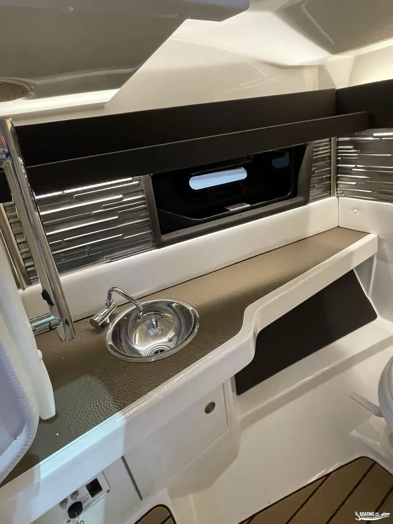 Slide: The Image of 2023 Sea Ray 310 SLX cabin interior with sink and window. - 15
