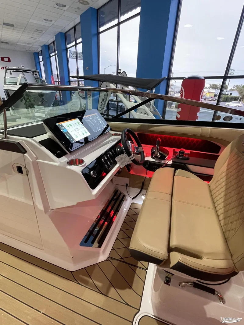 Slide: The Image of 2023 Sea Ray 310 SLX boat interior with modern dashboard and seating. - 17
