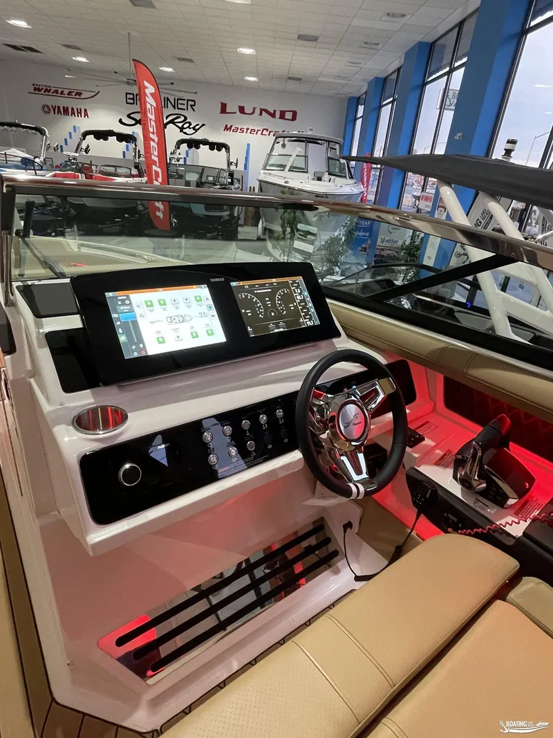 Slide: The Image of 2023 Sea Ray 310 SLX boat interior with modern dashboard and steering wheel. - 18
