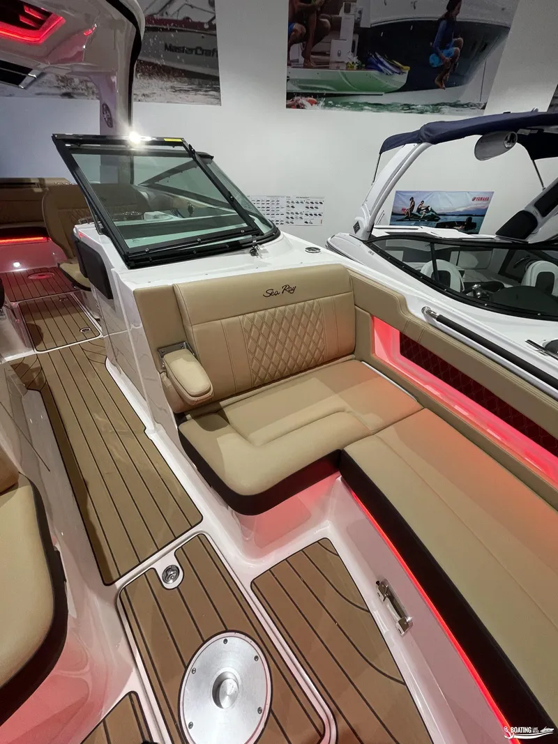 Slide: The Image of 2023 Sea Ray 310 SLX boat interior with tan seating and red accent lighting. - 21