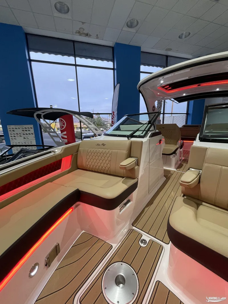Slide: The Image of 2023 Sea Ray 310 SLX boat interior with luxurious seating and ambient lighting. - 23