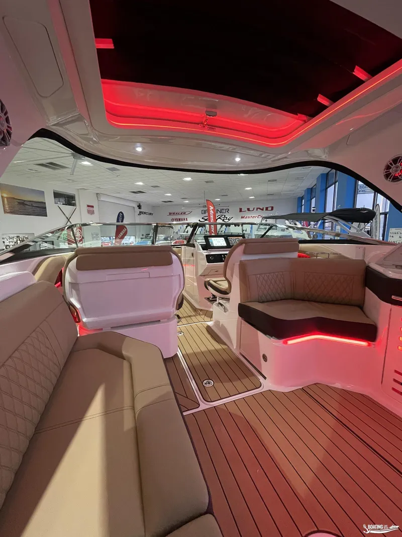 Slide: The Image of Luxurious interior of 2023 Sea Ray 310 SLX boat with ambient red lighting. - 25