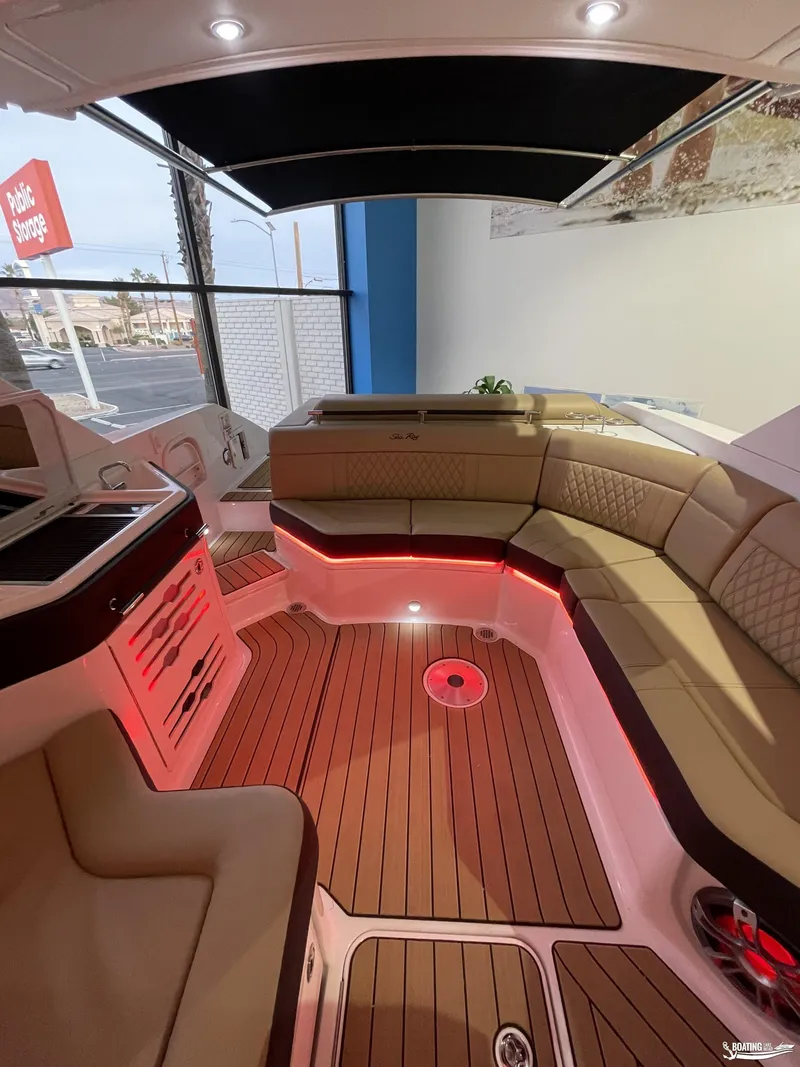Slide: The Image of Luxurious interior of 2023 Sea Ray 310 SLX boat with ambient lighting and plush seating. - 26