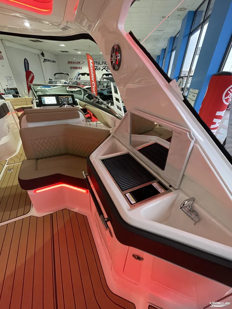 Slide: The Image of 2023 Sea Ray 310 SLX boat interior with seating and grill area. - 6