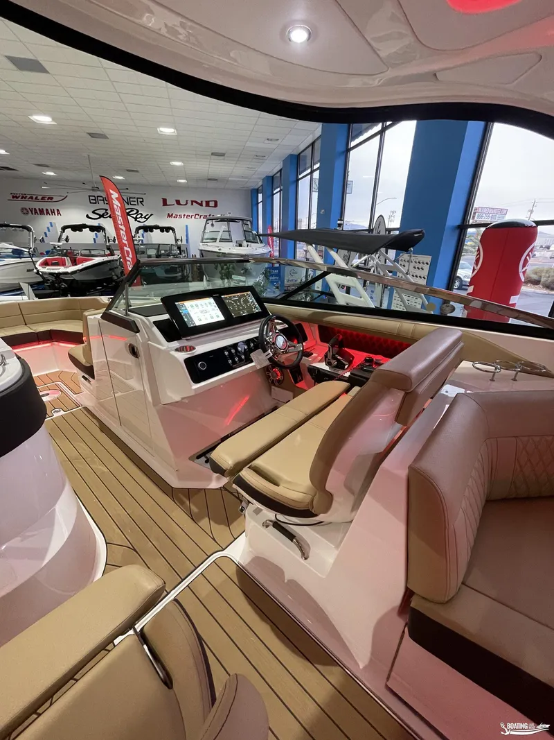 Slide: The Image of 2023 Sea Ray 310 SLX boat interior with modern dashboard and seating. - 7