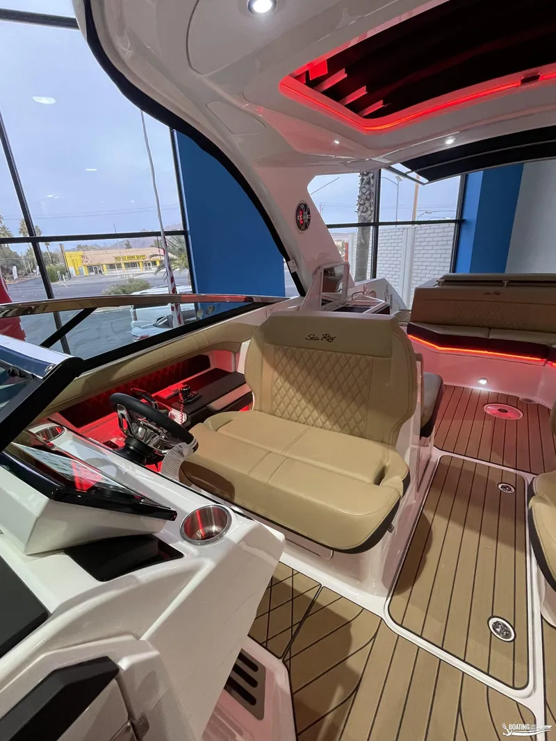 Slide: The Image of 2023 Sea Ray 310 SLX boat interior with luxurious seating and ambient lighting. - 9