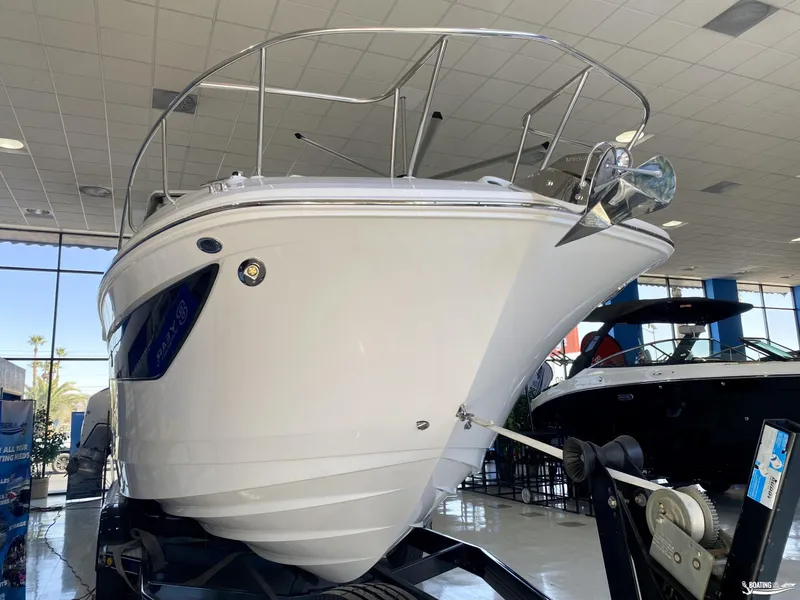 Slide: The Image of 2025 Sea Ray 320 Sundancer boat displayed in a showroom. - 2