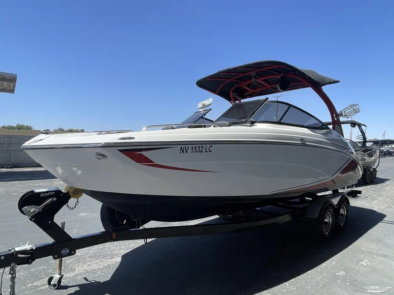 Slide: The Image of 2018 Yamaha Boats 242 X E Series on trailer under clear blue sky. - 0