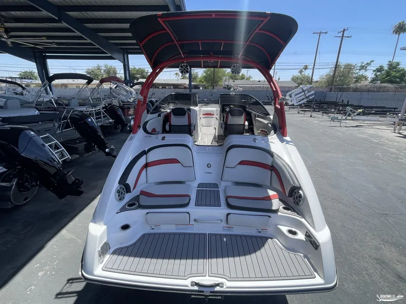 Slide: The Image of 2018 Yamaha Boats 242 X E Series, rear view, docked under a canopy. - 4