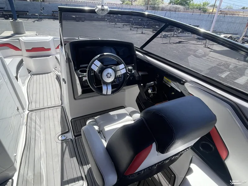 Slide: The Image of 2018 Yamaha Boats 242 X E Series cockpit with steering wheel and seating. - 5