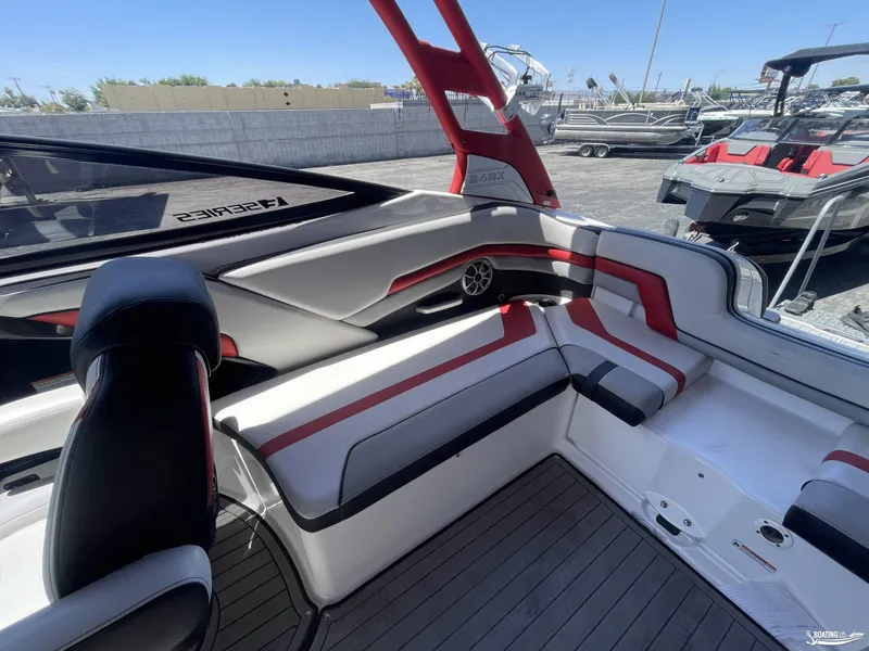 Slide: The Image of Interior of a 2018 Yamaha Boats 242 X E Series, featuring red and white seating. - 7
