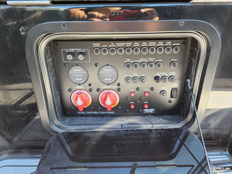 Slide: The Image of 2023 MasterCraft X26 12VDC distribution panel with switches and controls. - 13