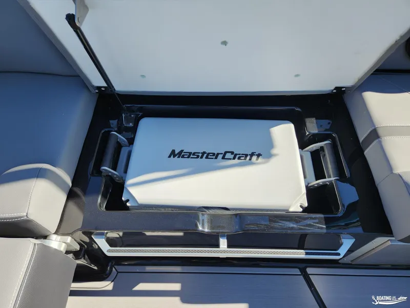 Slide: The Image of 2023 MasterCraft X26 boat storage compartment with branded cooler. - 15