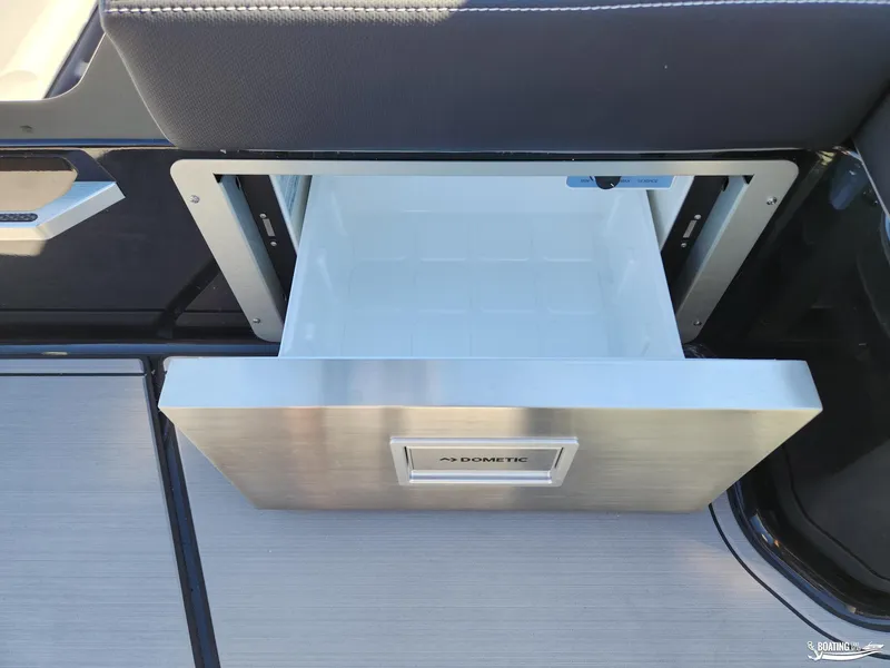 Slide: The Image of 2023 MasterCraft X26 boat with open Dometic drawer refrigerator. - 17