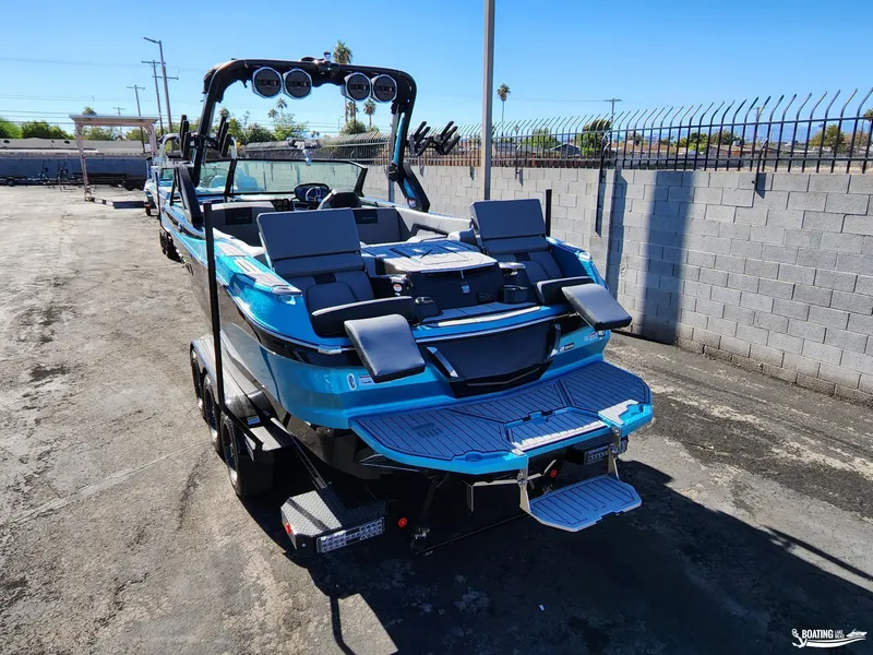 Slide: The Image of 2023 MasterCraft X26 boat in a parking lot, showcasing sleek design and vibrant blue color. - 21