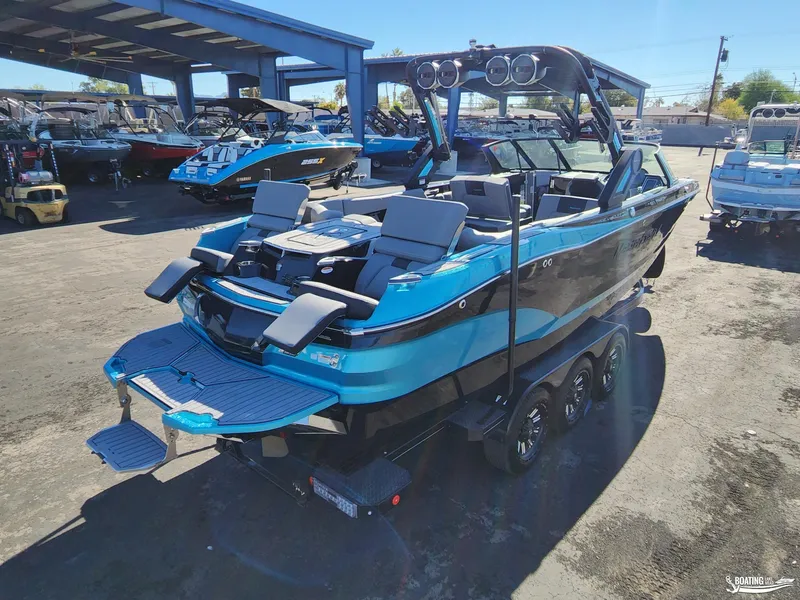 Slide: The Image of 2023 MasterCraft X26 boat in a showroom, featuring sleek design and modern amenities. - 23