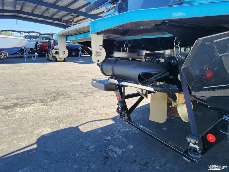 Slide: The Image of 2023 MasterCraft X26 boat undercarriage in a marina setting. - 24