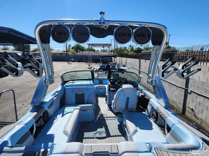 Slide: The Image of 2023 MasterCraft XT23 boat interior with seating and sound system. - 10