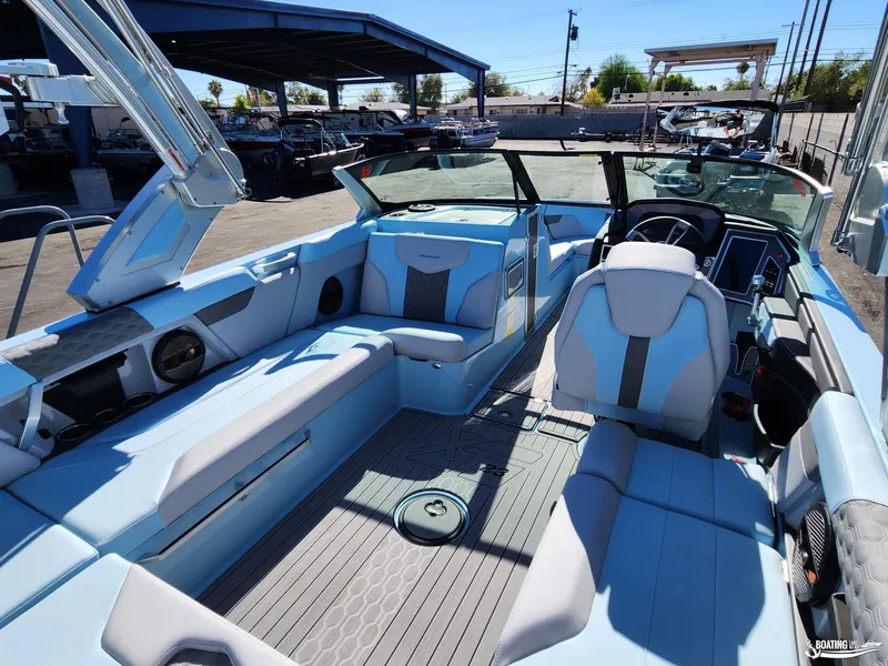 Slide: The Image of 2023 MasterCraft XT23 boat interior with blue seating and modern dashboard. - 11