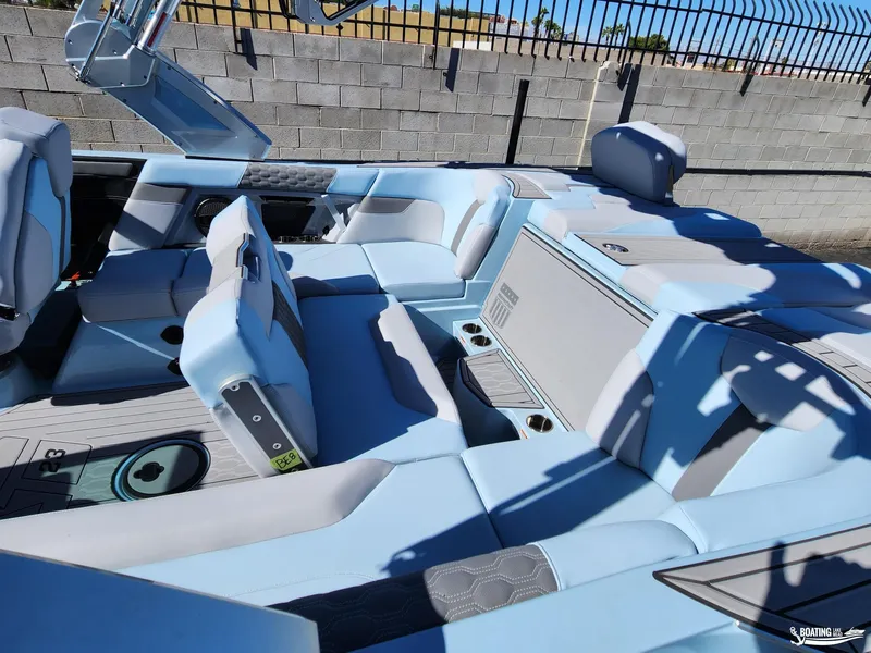Slide: The Image of 2023 MasterCraft XT23 boat interior with light blue seating and modern design. - 16