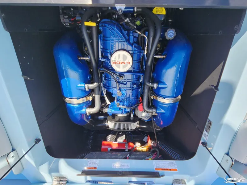 Slide: The Image of 2023 MasterCraft XT23 engine compartment with Ilmor engine, showcasing blue components. - 17