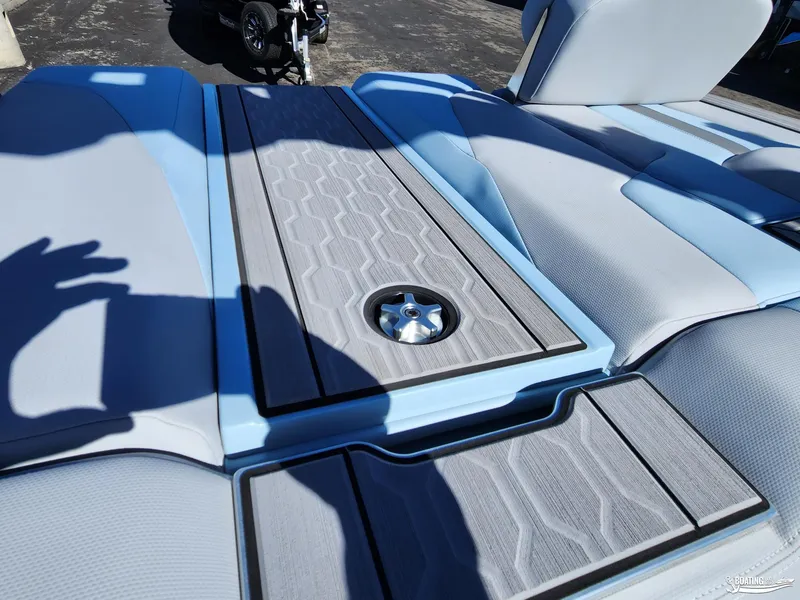 Slide: The Image of 2023 MasterCraft XT23 boat interior with blue and gray seating and deck. - 18