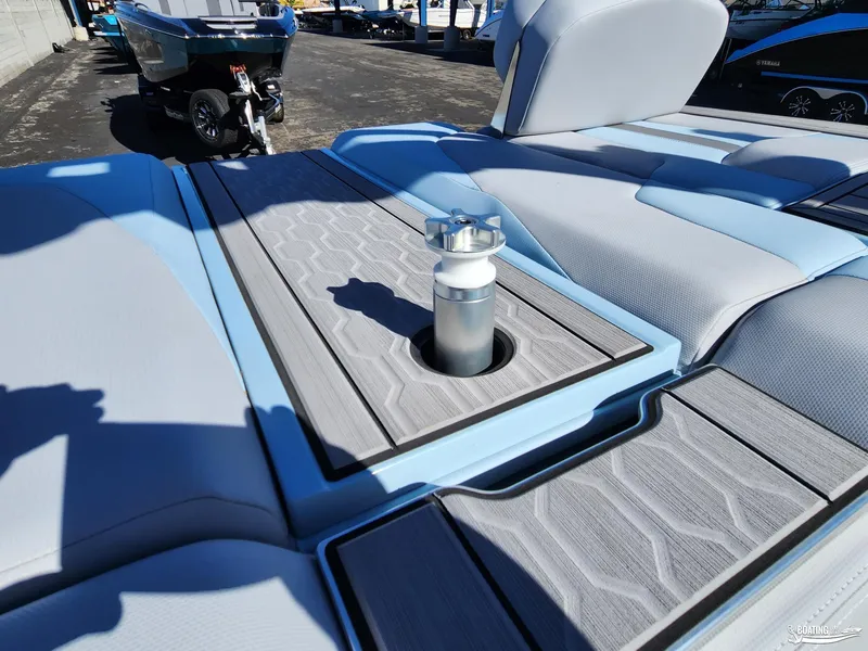 Slide: The Image of 2023 MasterCraft XT23 boat interior with light blue and gray seating. - 19