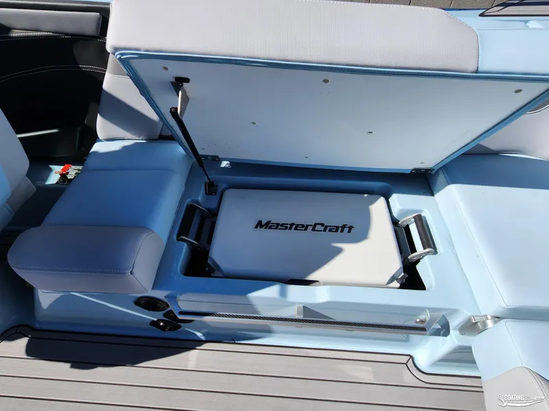 Slide: The Image of 2023 MasterCraft XT23 boat interior with open storage compartment. - 20
