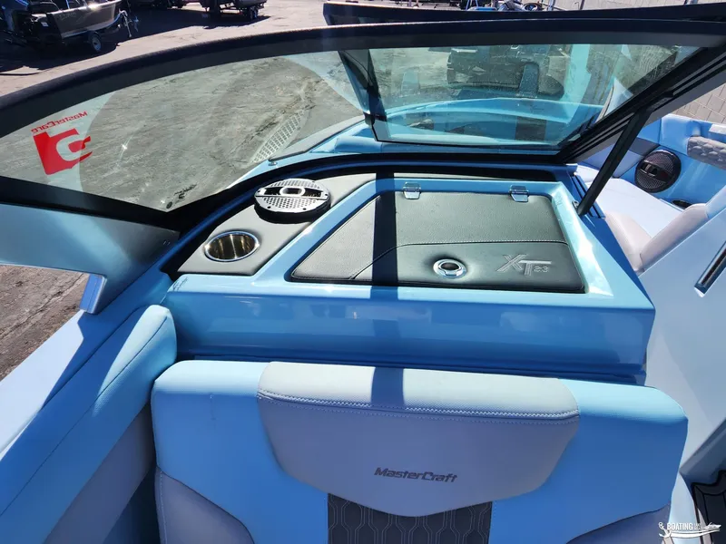 Slide: The Image of 2023 MasterCraft XT23 boat interior with blue seating and windshield. - 22