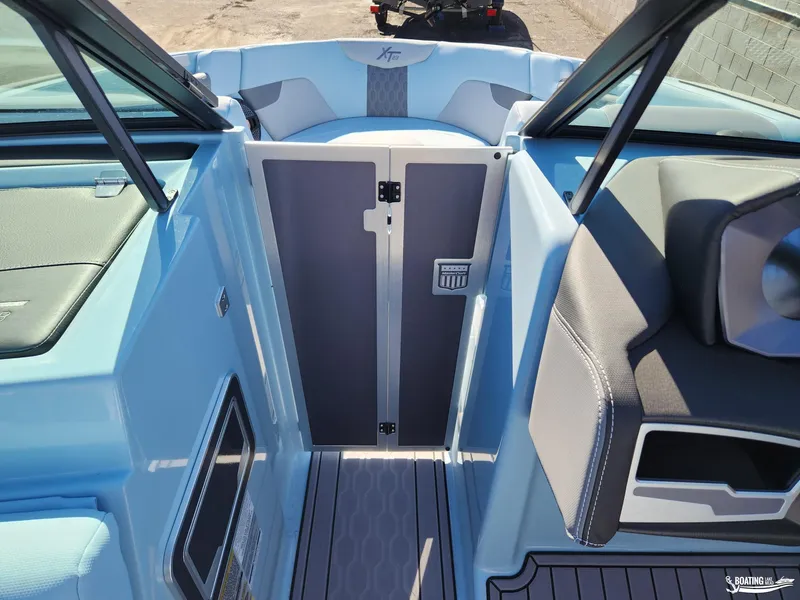 Slide: The Image of 2023 MasterCraft XT23 boat interior with sleek seating and modern design. - 23