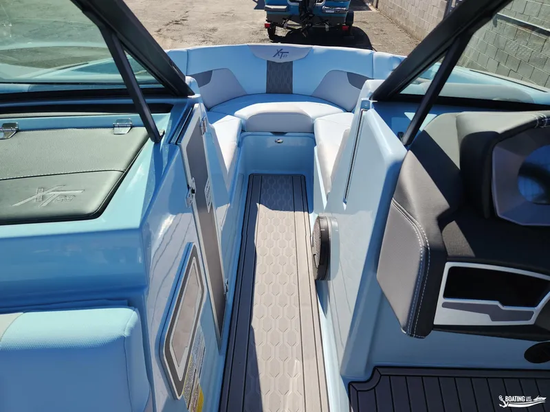 Slide: The Image of 2023 MasterCraft XT23 boat interior with sleek seating and modern design. - 24