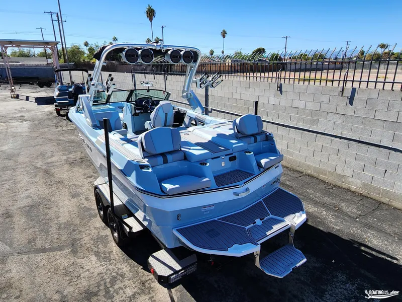 Slide: The Image of 2023 MasterCraft XT23 boat with sleek design, parked outdoors on a sunny day. - 8