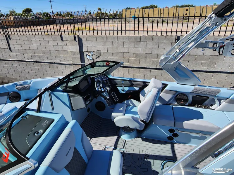 Slide: The Image of 2023 MasterCraft XT23 boat interior with modern dashboard and seating. - 9