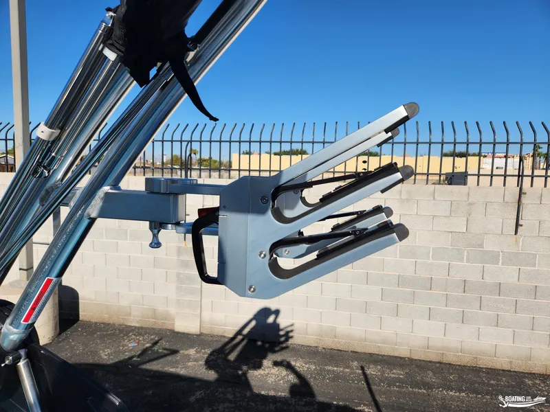 Slide: The Image of 2023 MasterCraft NXT20 wakeboard rack against a clear blue sky. - 13