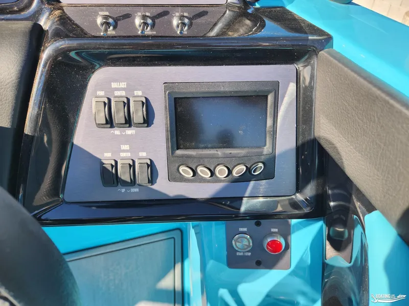 Slide: The Image of 2023 MasterCraft NXT20 boat dashboard with control panel and display screen. - 16