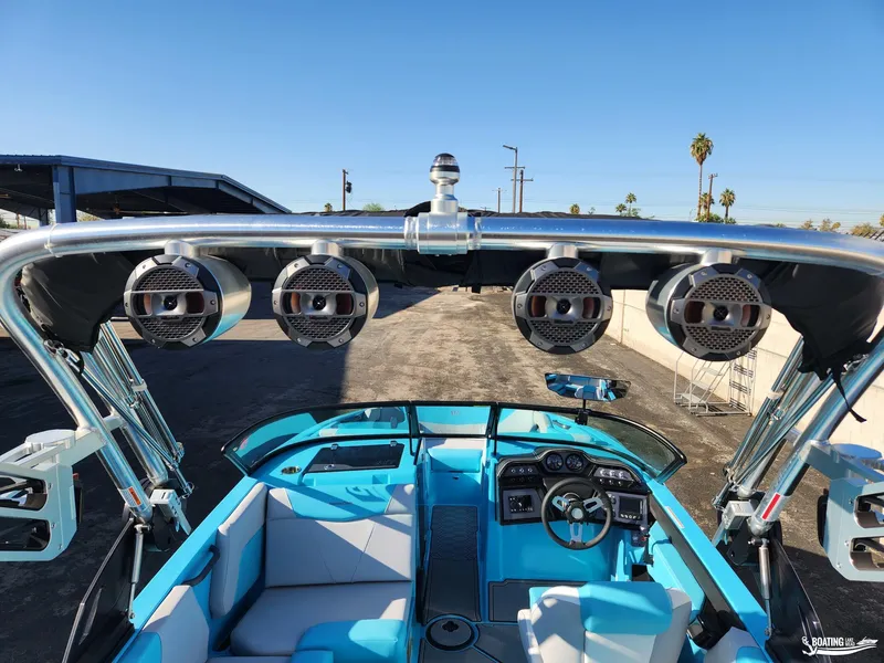 Slide: The Image of 2023 MasterCraft NXT20 boat interior with speakers and blue seating. - 17