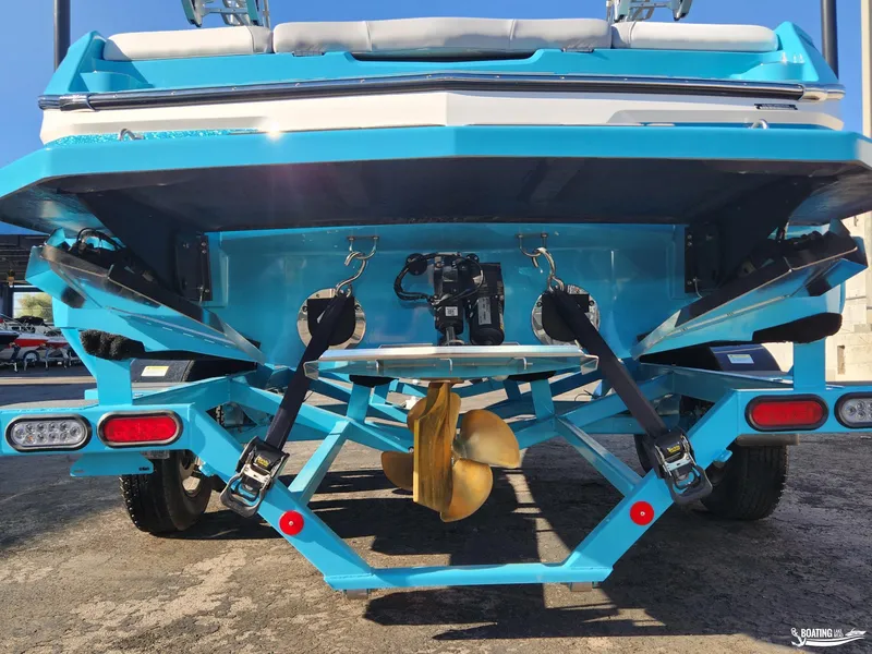 Slide: The Image of 2023 MasterCraft NXT20 boat rear view with propeller and trailer. - 23