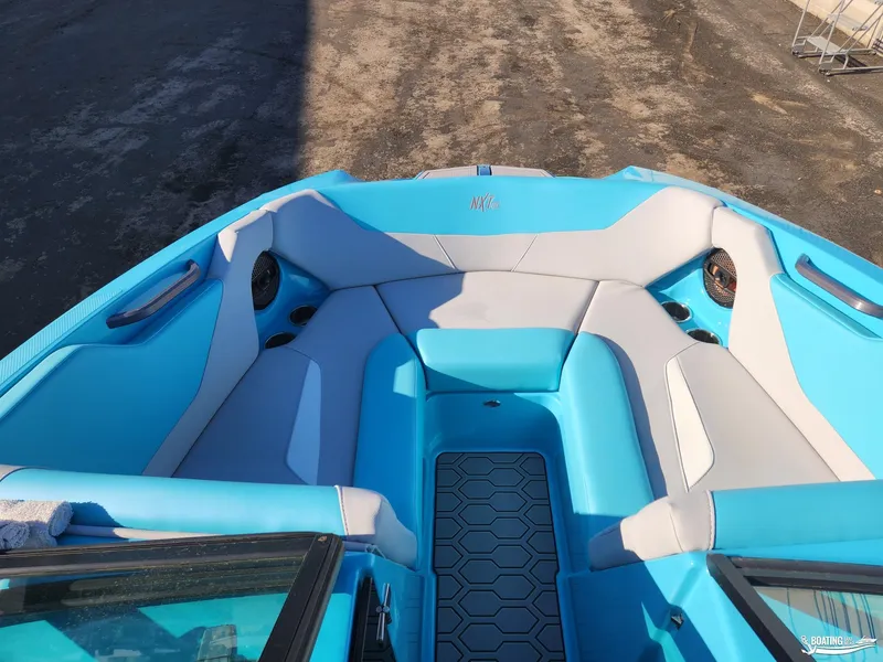 Slide: The Image of 2023 MasterCraft NXT20 boat interior with blue and gray seating. - 6