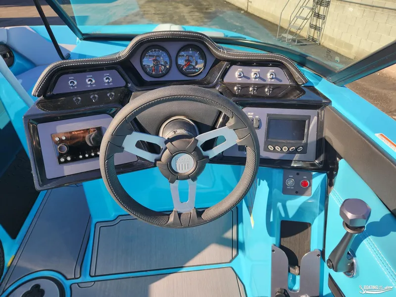 Slide: The Image of 2023 MasterCraft NXT20 boat dashboard with steering wheel and control panel. - 8