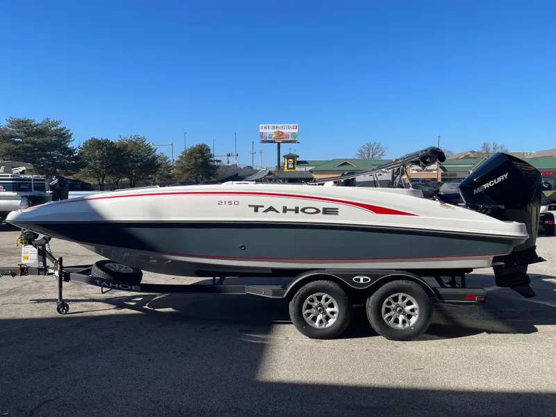 The Image of 2023 Tahoe 2150 boat on a trailer in a parking lot. - 0
