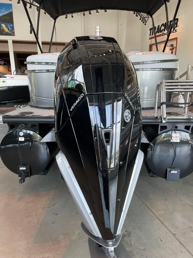 Slide: The Image of 2023 Regency 230 LE3 boat with a powerful black Verado engine. - 3