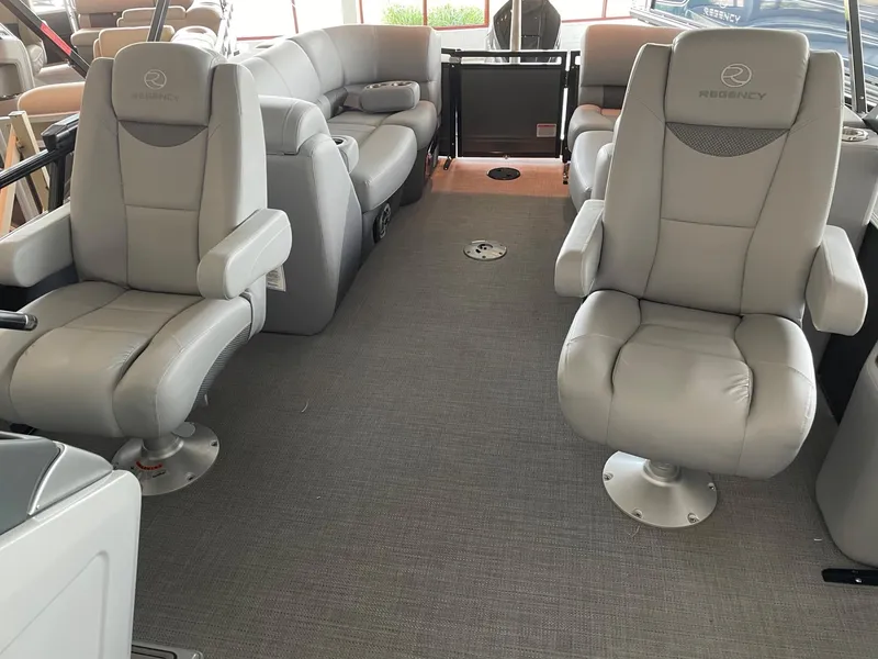 Slide: The Image of 2023 Regency 230 LE3 boat interior with plush seating and modern design. - 7