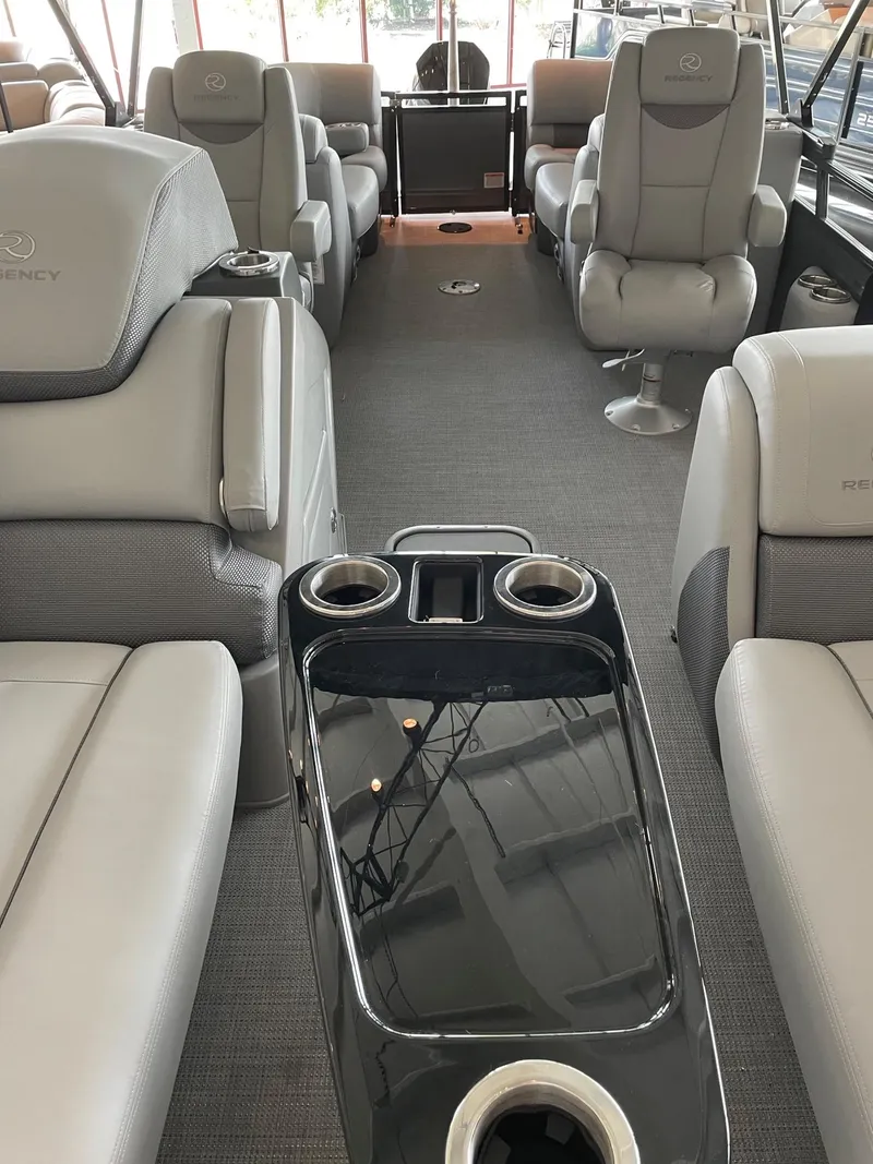 Slide: The Image of 2023 Regency 230 LE3 boat interior with luxurious seating and cup holders. - 8